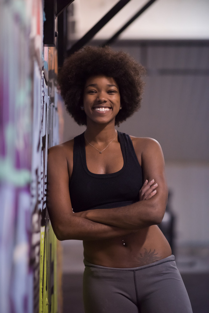 portrait of a young beautiful African American women in sports clothes after a workout at the gym