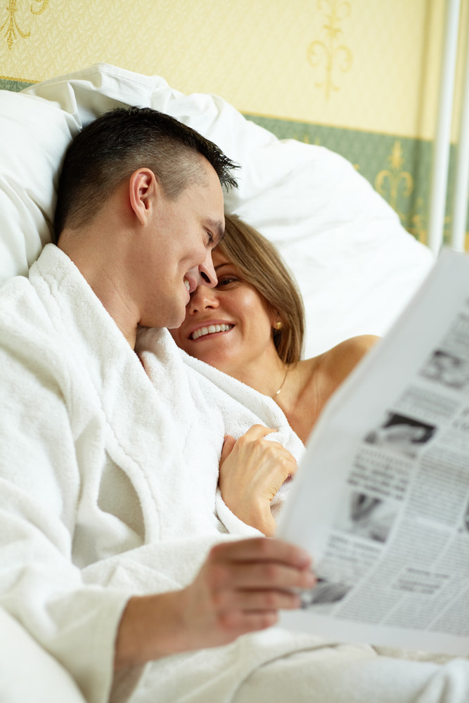 Married Couple Lying In Bed In The Morning Royalty Free