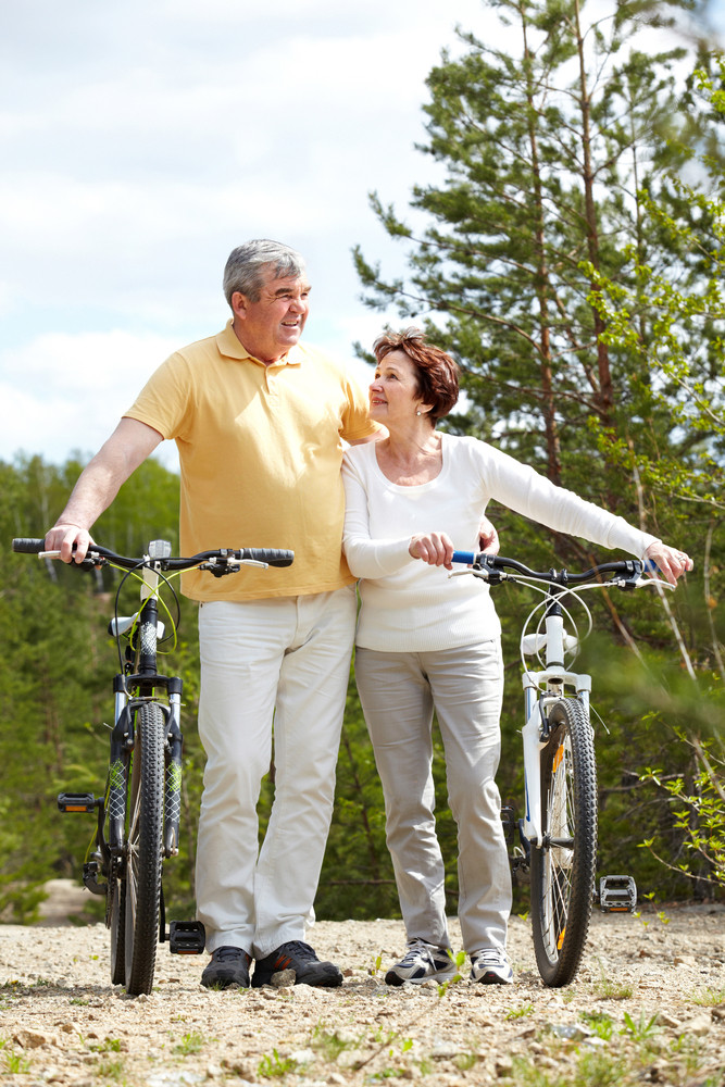 Portrait of mature couple with bicycles on weekend