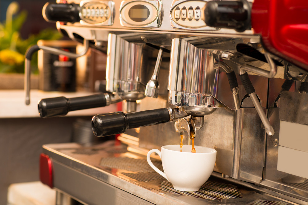 Image of a modern coffee machine making tasty coffee in the coffee shop