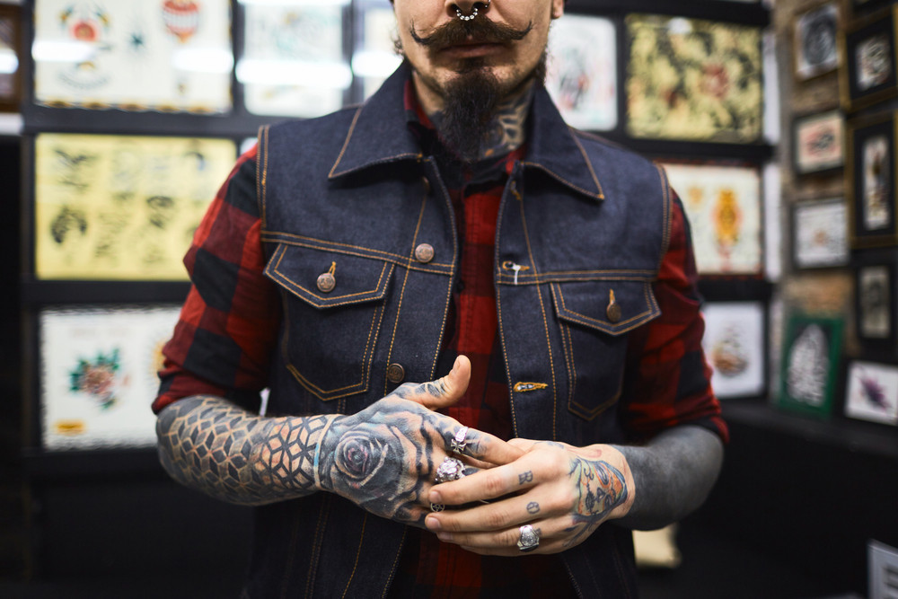 Midsection of professional modern tattoo-salon owner
