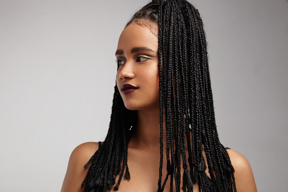 black woman\'s profile. African braids. false hair concept
