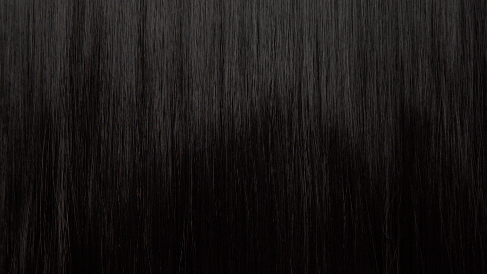 Hair texture background, no person. Black shiny hair comb texturte