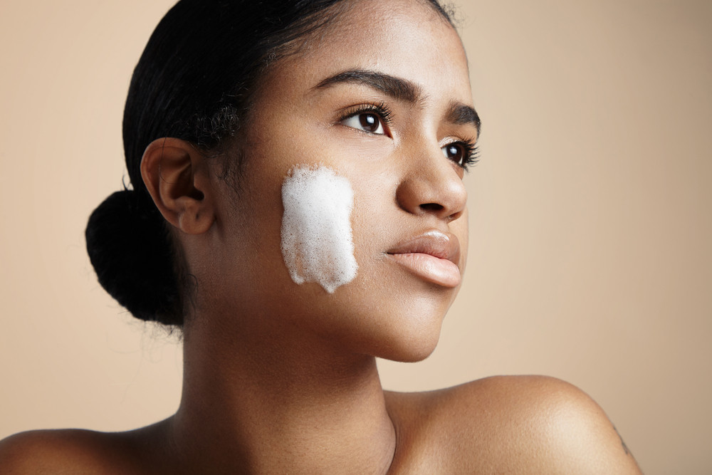woman with a soap foam on a cheek