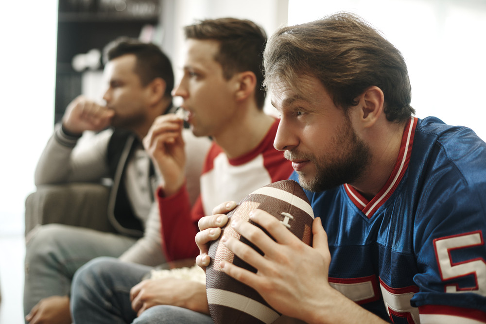 Focused watching football game at home Royalty-Free Stock Image ...