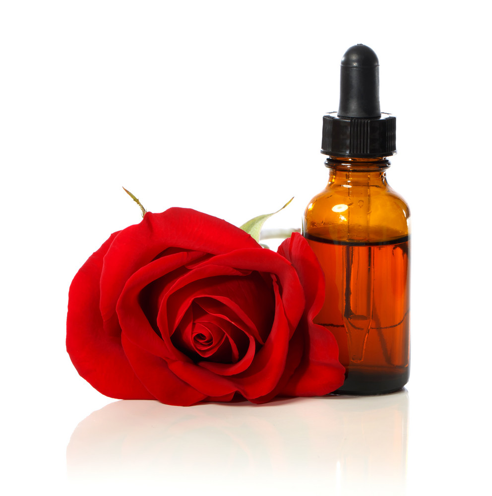 Dropper Bottle With Beautiful Red Rose Over White Background