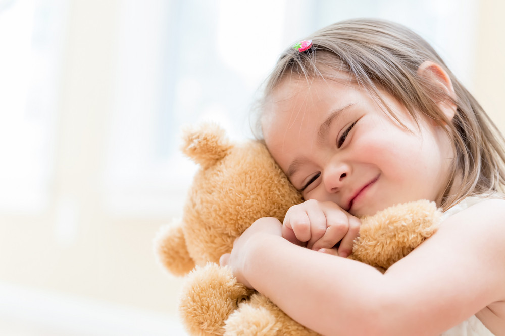 little girl with a teddy bear