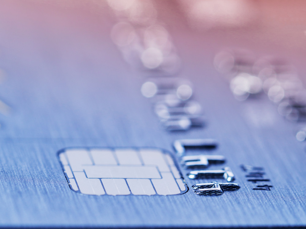 Low angle view of the microchip and raised numbers on a bank card with the expiry date below with shallow dof in a conceptual image
