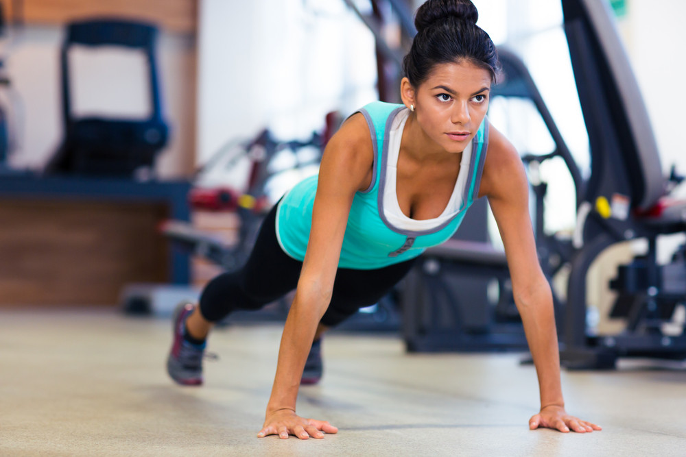 Woman doing push ups in gym Royalty-Free Stock Image - Storyblocks