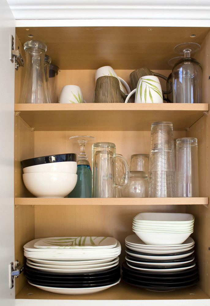 A full cabinet full of dishes and plates.