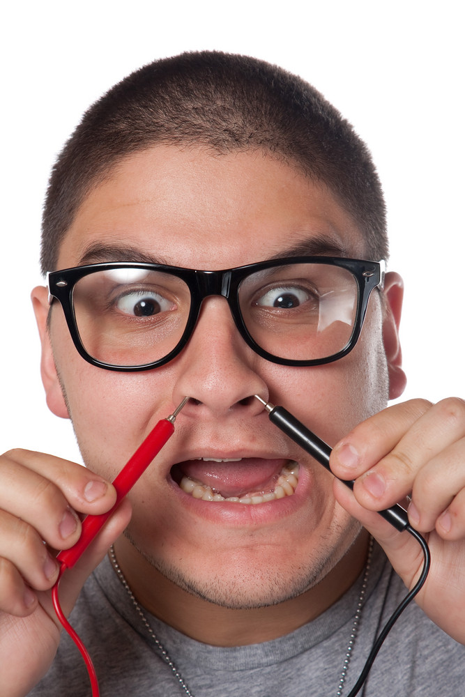 A goofy man wearing trendy nerd glasses isolated over white with a ...