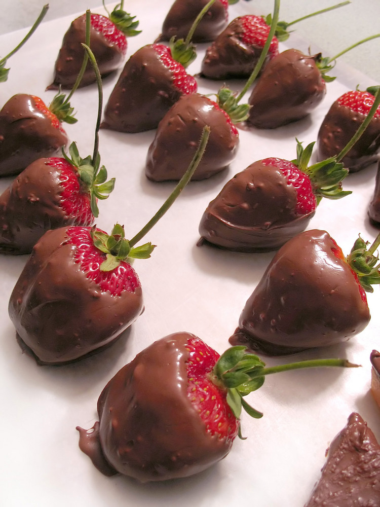 A tray of freshly dipped chocolate covered strawberries. Delicious!