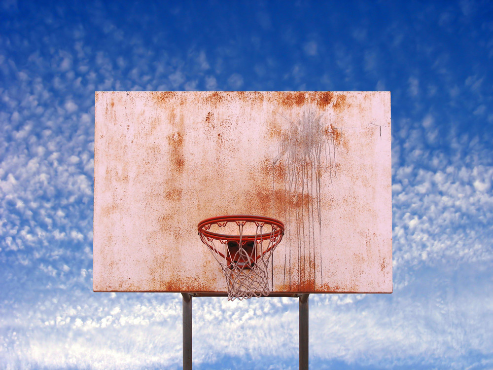 An basketball hoop found in an urban park over a blue sky - includes clipping path.