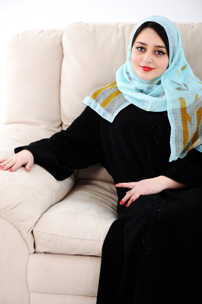 Arabic woman sitting on sofa at home