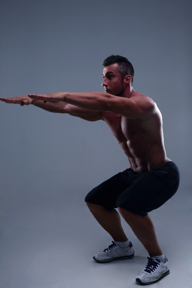 Athletic Young Muscular Man Doing Squats Royalty Free Stock Image