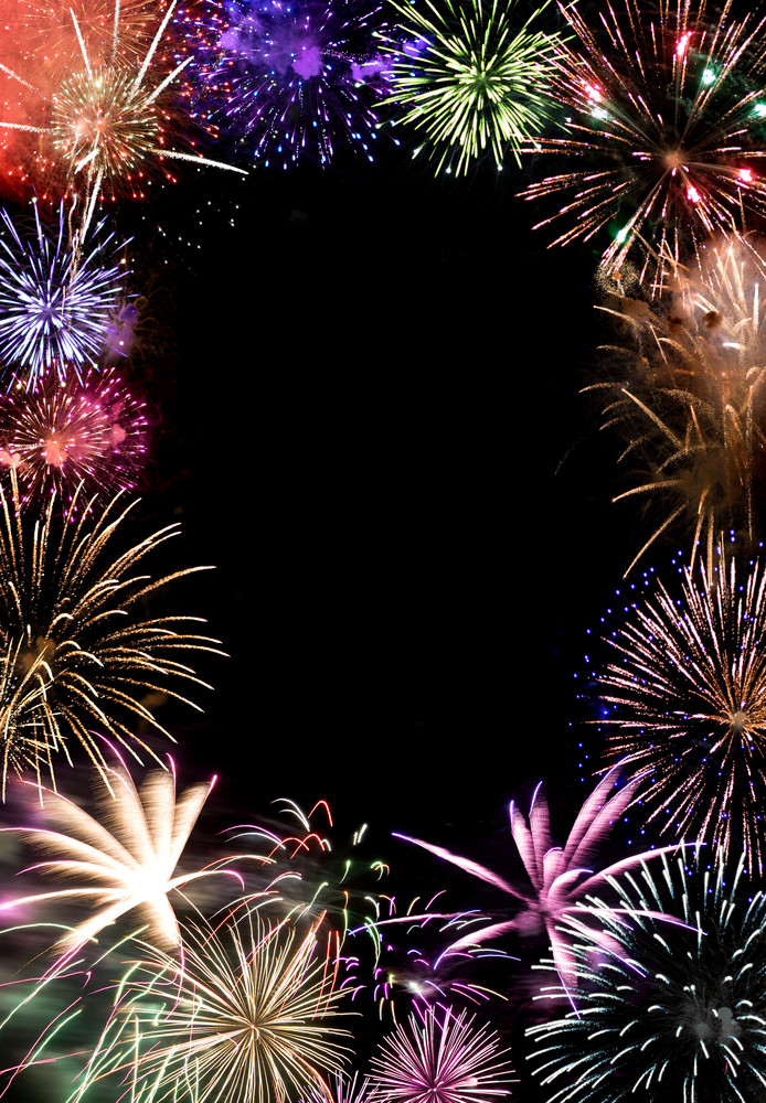 Beautiful fireworks exploding over a dark night sky with copy space in the center. Works great as a greeting card or ad layout.