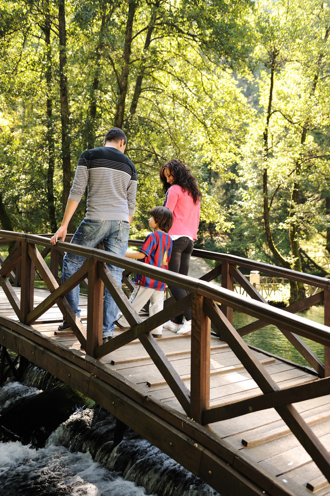 Beautiful Scene Of Young Happy Family Walking In Nature Together