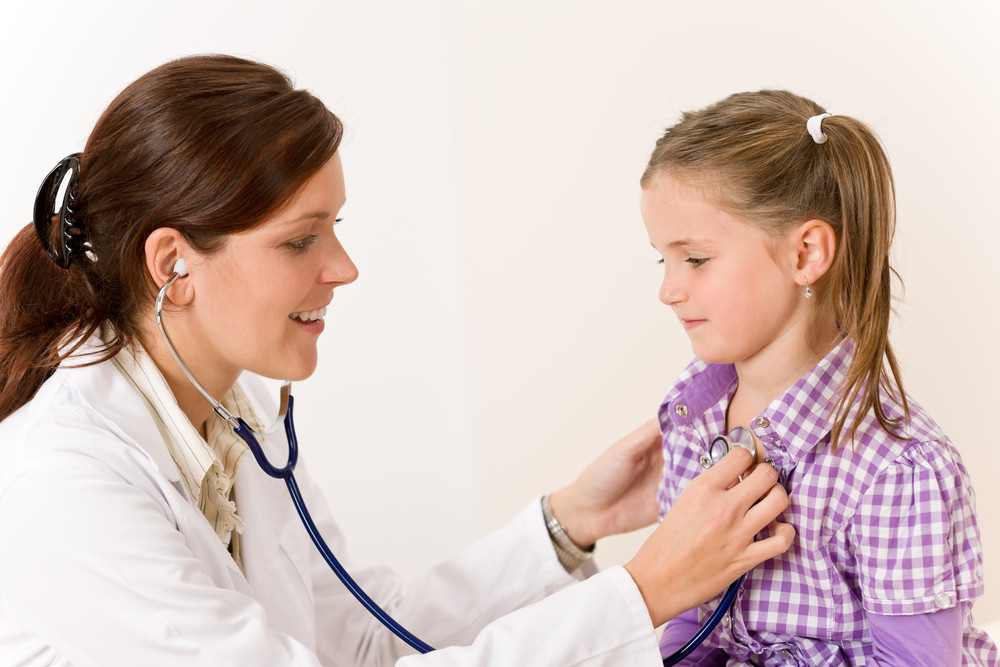 female-doctor-examining-child-with-stethoscope-at-surgery-royalty-free