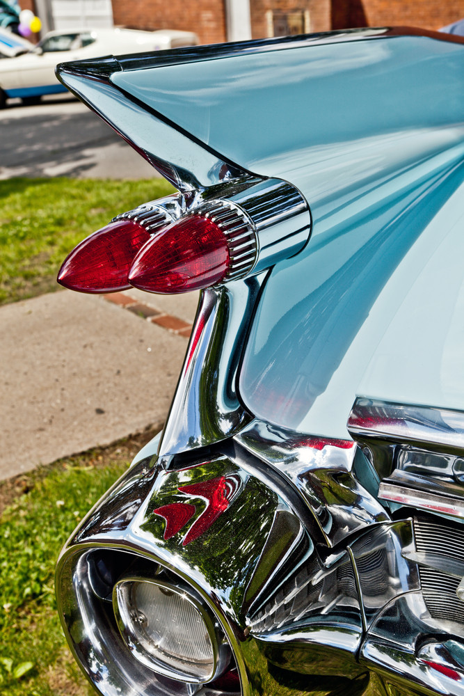 Classic car vintage tail lights and rear chrome bumper.