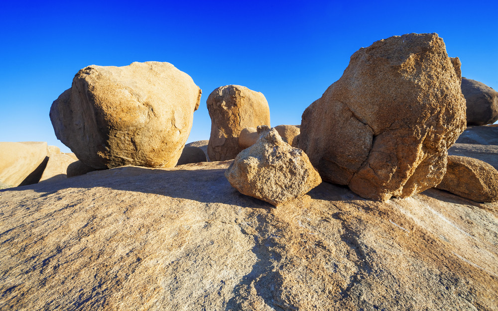 Sun-bleached rocks under a blue sky Royalty-Free Stock Image - Storyblocks