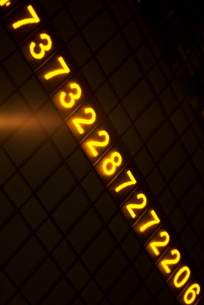 Digital readout of numbers on an electronic sign at night.