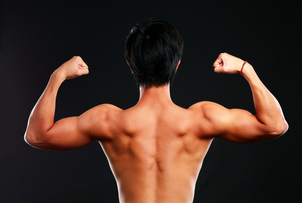 fitness muscled man back on black background