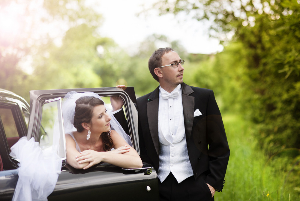 Beautiful Happy Young Bride And Groom Posing By The Retro Car