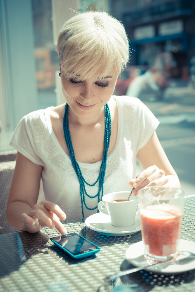 Beautiful Young Blonde Short Hair Hipster Woman Using Smart Phone