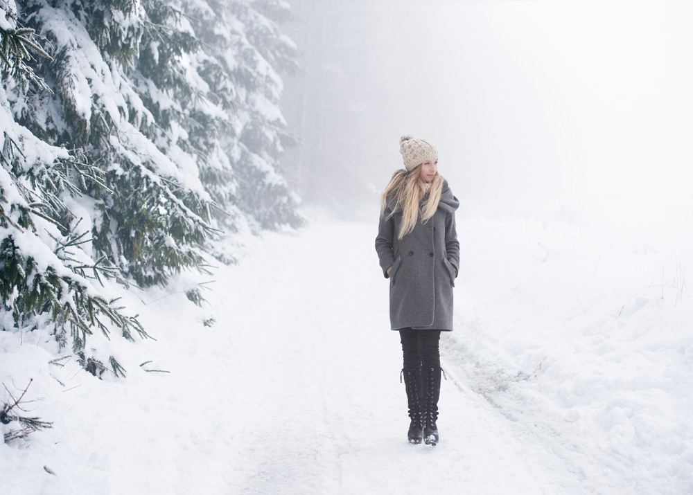 Beautiful Young Blonde Woman In Gray Coat On A Walk In Winter Nature