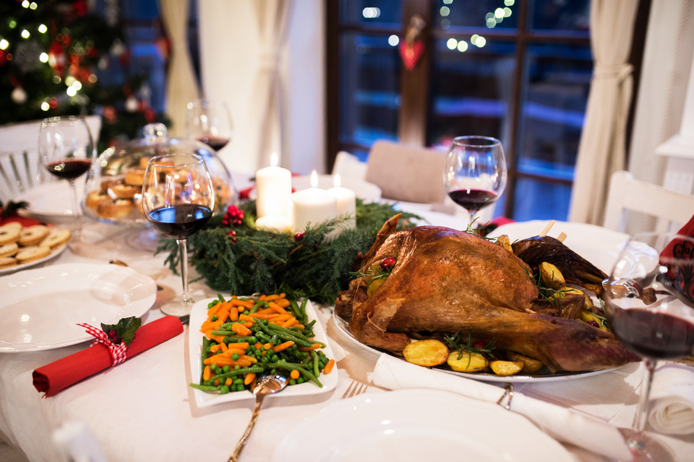 Christmas Meal Laid On Table In Decorated Dining Room Roasted