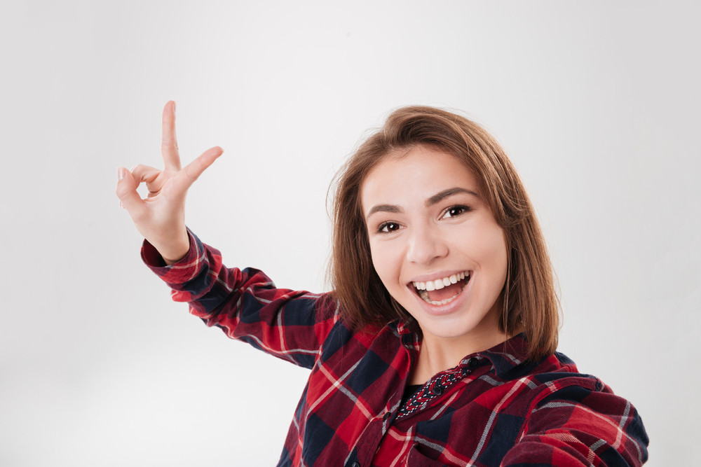 Close Up Portrait Of A Cute Lovely Woman Taking Selfie And Showing 