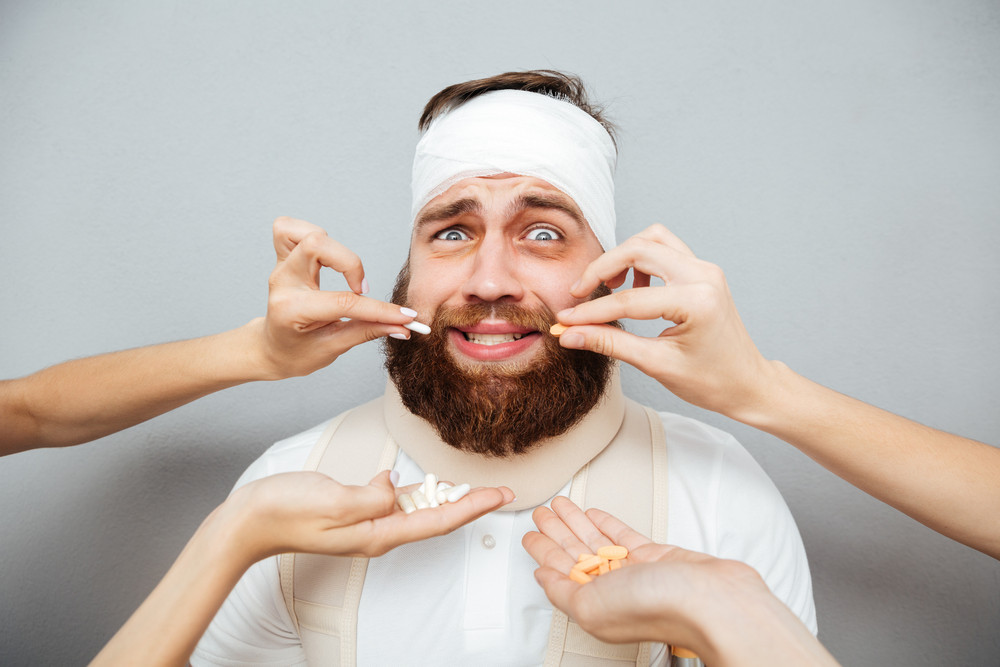 graphicstock-frightened-scared-bandaged-man-taking-pills-from-doctors-hands-over-gray-background_HOWuvLBH2e_SB_PM.jpg