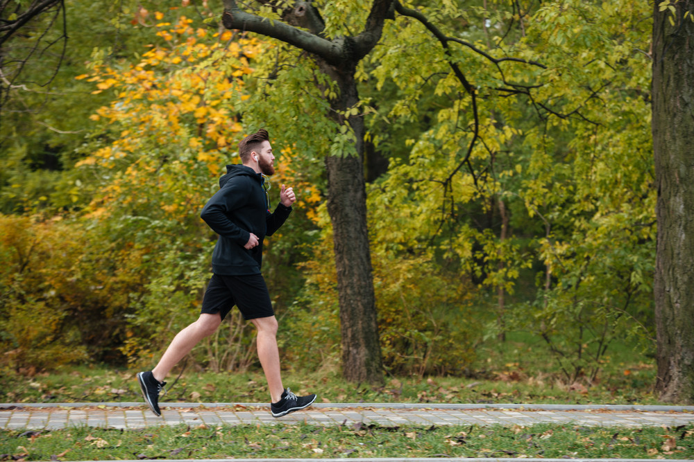 Full length of runner in park. side view Royalty-Free Stock Image ...