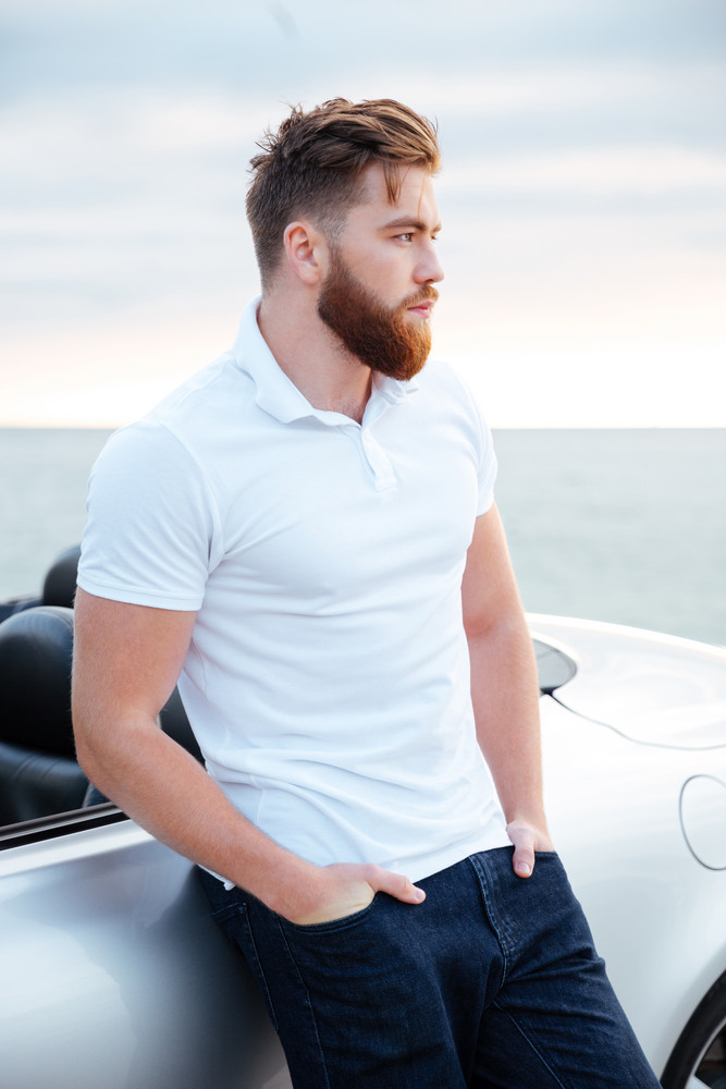 Handsome Bearded Man In White Shirt Leaning On Car While Standing On