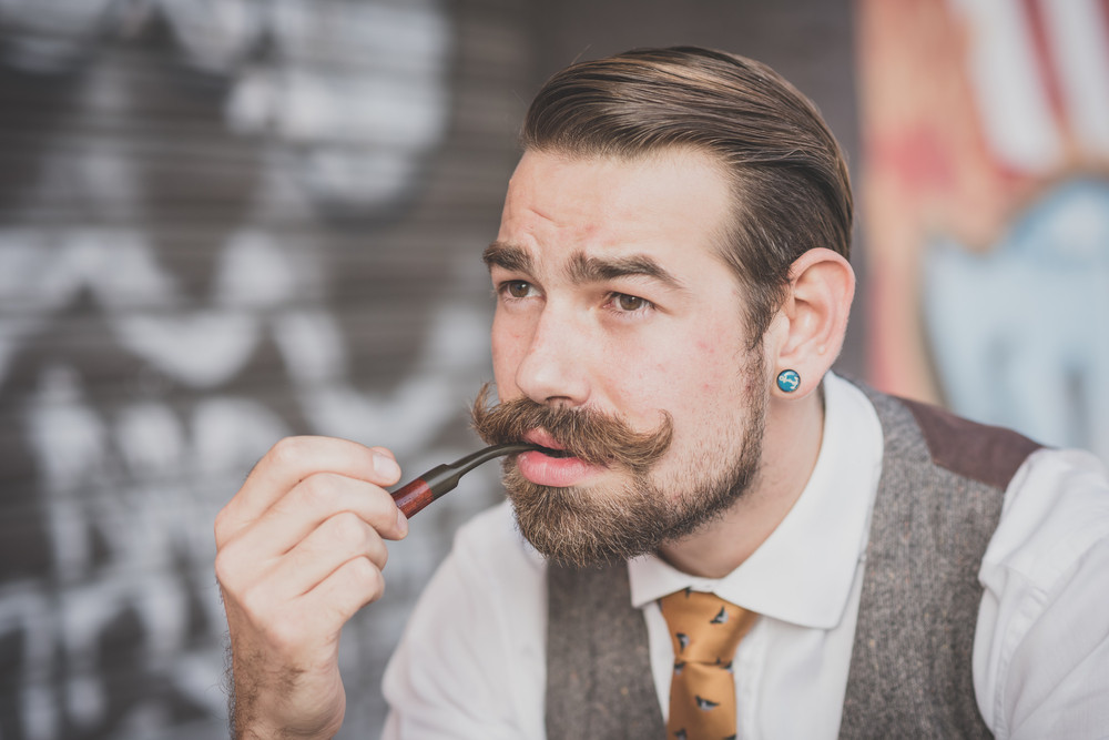 handsome big moustache hipster man smoking pipe in the city Royalty ...