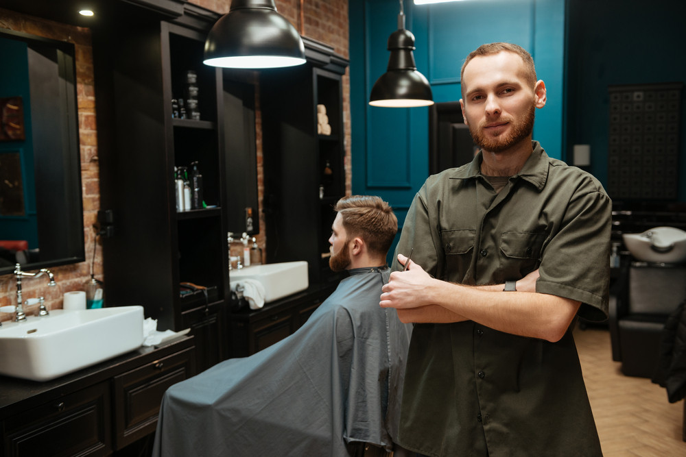 Happy Young Hairdresser Standing Near His Client Looking At