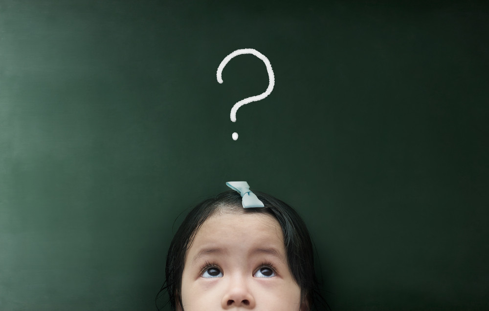 little girl thinking with question mark over her head