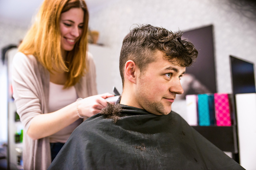 Professional Hairdresser Shaving Head Of Her Young Client Making