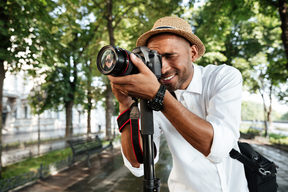 Smiling black man in park with camera Royalty-Free Stock Image ...