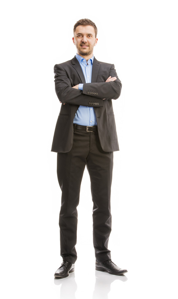 Successful business man in suit is posing in studio isolated over white ...