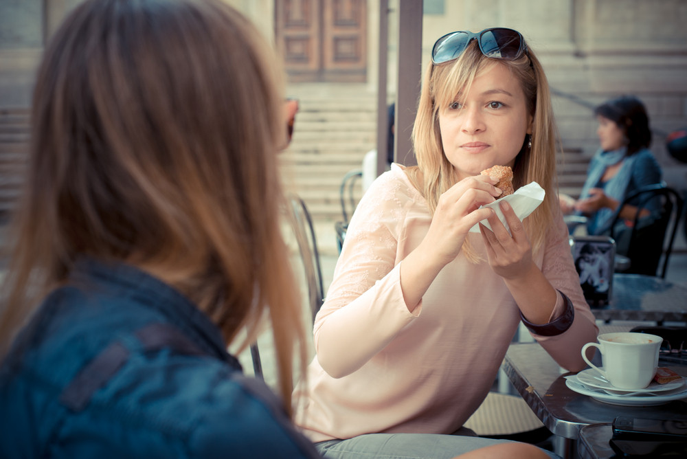 Two Beautiful Blonde Women Talking At The Bar In The City Royalty Free 