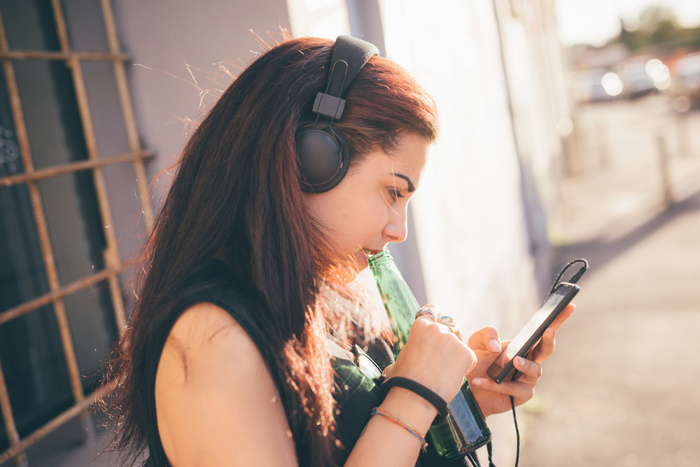 Young Beautiful Reddish Brown Hair Caucasian Woman Listening To