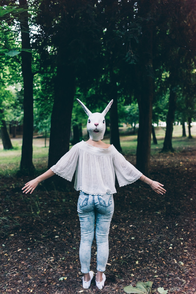 young woman wearing rabbit mask - carnival, halloween, surreal concept ...