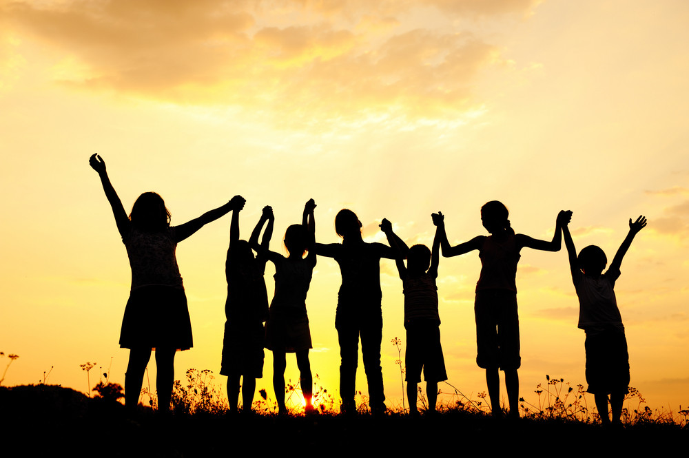 Group of happy children playing at summer sunset in nature Royalty-Free ...