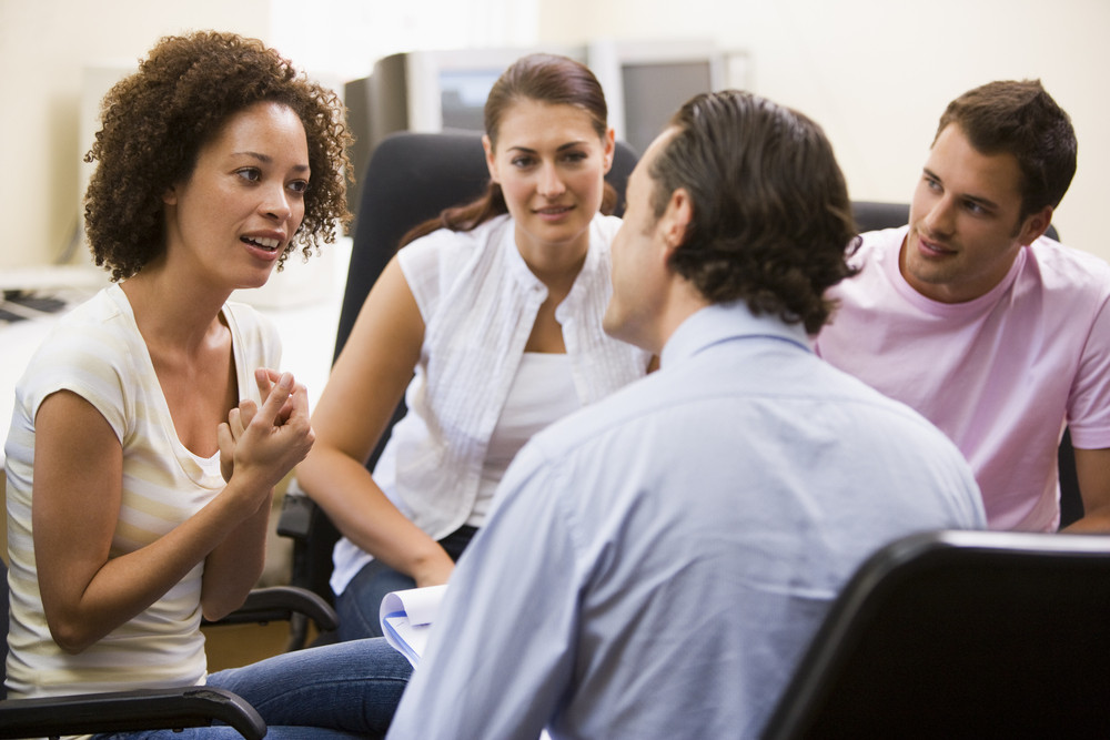 Man Giving Lecture To Three People In Computer Room Royalty-free Stock 