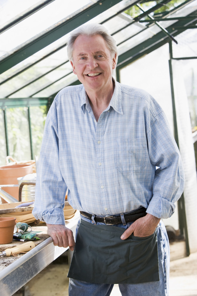 Man in greenhouse smiling