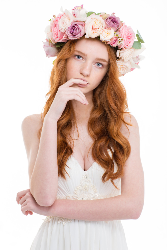 Portrait Of A Beautiful Redhead Woman With Wreath From Flowers On Head