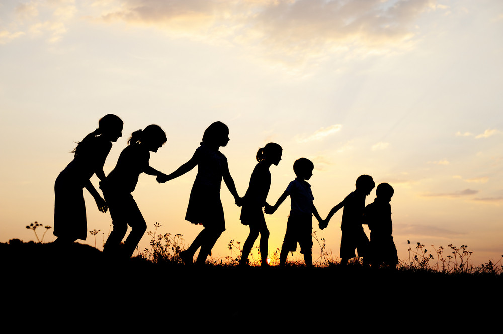 Silhouette, group of happy children playing on meadow, sunset ...