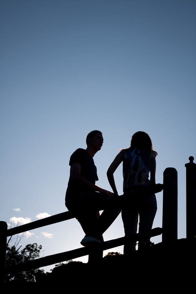 Silhouette Of A Young Couple Hanging Out Together Outdoors By An Old Country Fence During The Early Evening Hours Stock Images Page Everypixel