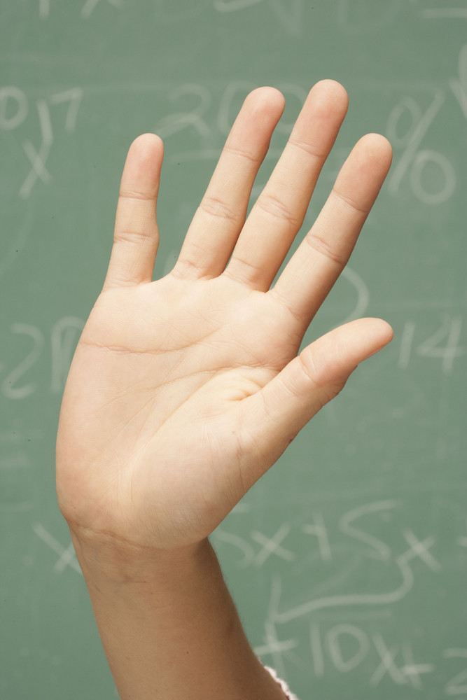 Student\'s hand raised in classroom